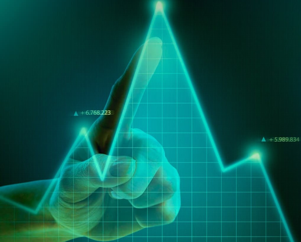 Trader pointing at chart, using on-chain analysis to determine an assets price