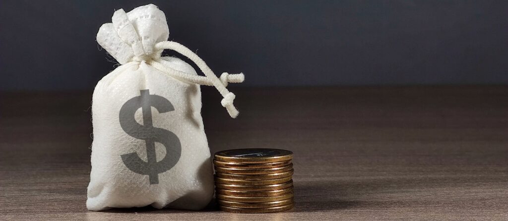 stack of coins next to a money bag acting as reserve cash